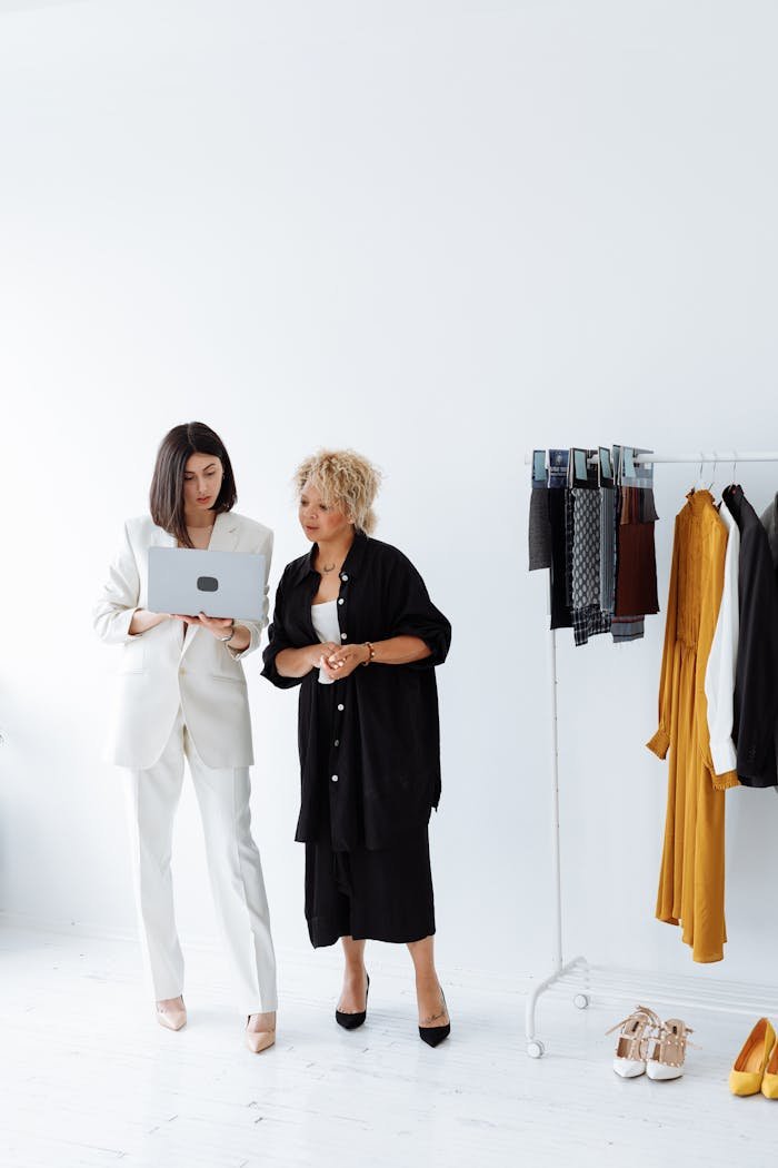 Woman in White Suit Holding White Laptop